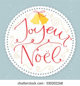 Joyeux Noel - french phrase means Merry Christmas. Modern calligraphy with swirls at round paper frame on pastel blue background. Vintage style vector illustration for greeting cards.