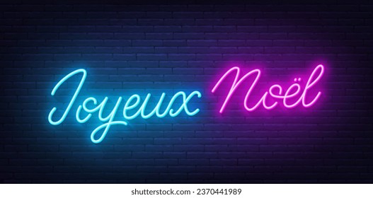 Joyeux Noel neon lettering on brick wall background. Merry Christmas greetings in French.