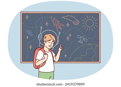 Joyful boy with backpack behind back stands near blackboard depicting universe with spaceships and planets. Schoolboy is fond of astronomy with drawings of UFOs and satellite ships. Flat vector image