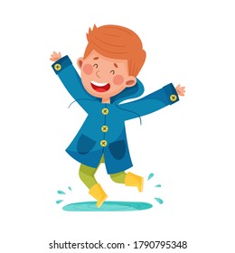 Joyful Boy Character in Rubber Boots and Raincoat Jumping in Puddle Vector Illustration