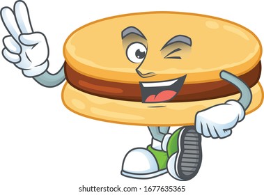 A joyful brown alfajor mascot design showing his two fingers