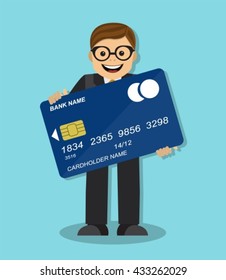 joyful businessman standing and holding a credit card