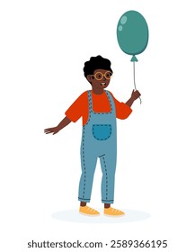 Joyful child holding a balloon while wearing colorful overalls and glasses