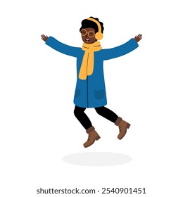 A joyful child jumping in a blue winter coat with yellow accessories during cold weather