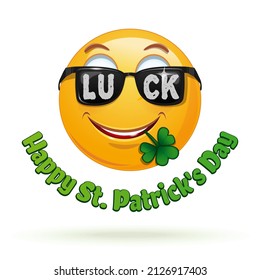 Joyful emoticon in dark glasses and clover leaves in the mouth. Emoji for St. Patrick's Day. Happy St. Patricks Day. Vector illustration