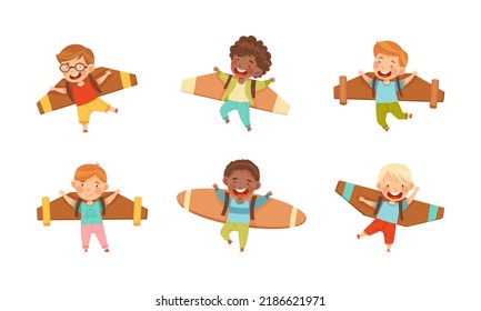 Joyful kids playing pilots with cardboard wings set vector illustration