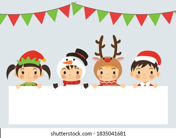 Joyful kids in variety Christmas costumes are behind blank space text box. Cute little christmas Children. greeting card of merry Christmas and happy New Year. 