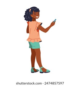 Joyful and stylish young African American girl with curly hair happily taking a selfie on her smartphone. She is exuding confidence and happiness, dressed in a trendy outfit. The background is white.