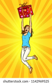 Joyful young woman jumping up with a gift. Pop art retro vector illustration kitsch vintage