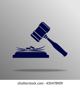 judge gavel and stack of money on a gray background