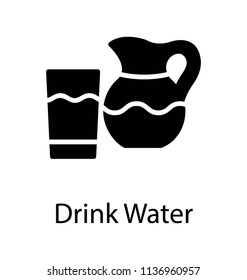 A jug and a glass filled with water for drinking purpose 