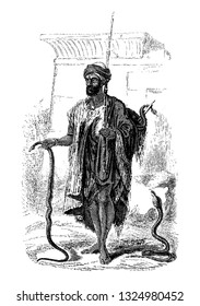 The Juggler carrying cobra capella in both hands which were the most terrible species of snakes, vintage engraved line art illustration. Infernal Dictionary 1863.