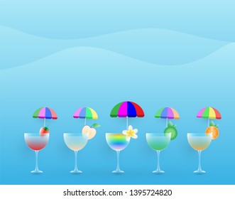 Juice of various fruit and rainbow cocktail in champagne glass with small umbrella for decoration
