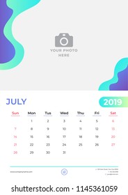 July 2019 calendar design.Simple green and purple background. Week starts on Sunday. Vector design print template with place for photo. 
