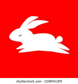 Jumping ,running bunny on an isolated red background.Icon.