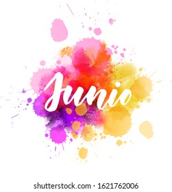 Junio (June in Spanish) -  handwritten modern calligraphy lettering on abstract watercolor imitation splash. 