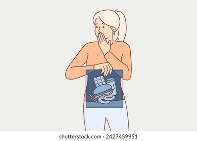 Junk food in stomach of woman holding x-ray and fearfully covering mouth with hand. Concept of digestive problems caused by eating junk food containing cholesterol and causing obesity