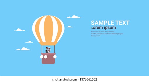 just married bridegroom and bride flying in air balloon romantic african american couple in love wedding day concept blue background copy space full length horizontal flat
