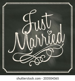 Just Married lettering sign on chalkboard background 