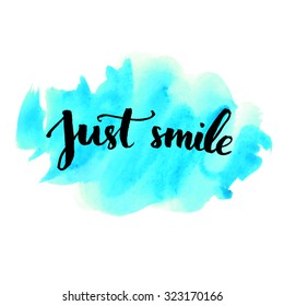 Just smile - inspirational quote handwritten on blue watercolor strokes background. Vector lettering for cards, prints and social media content, fashion design. Positive quote.