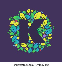 K letter logo in a circle of leaves and flowers. Font style, vector design template elements for your vegan or ecology application or corporate identity.