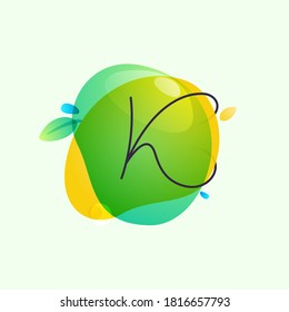 K letter logo placed on green watercolor blots. Overlapping splashes typeface can be used for ecology banner, natural lifestyle poster, vegan identity, etc.