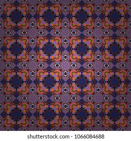 Kaleidoscopic seamless pattern in magenta, purple and blue colors. It can be used in the design of textiles, in the printing industry. Vector illustration.