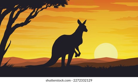 A kangaroo facing the sun at sunset
