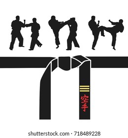 Karate belt, men demonstrating karate. A hieroglyph on the belt - Karate (Japanese) 