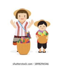 Karen child in northern of thailand in traditional costume and basket with vegetables.