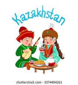 Kazakhstan. A boy and a girl in national costumes. Girl drinks tea, boy plays on dombra