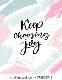 Keep choosing joy. Positive inspirational quote. Brush calligraphy on pink and blue pastel strokes