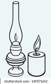 Kerosene lamp and candle isolated on blue background