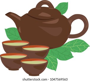 A kettle and four cups with green leaves stand on the leaves