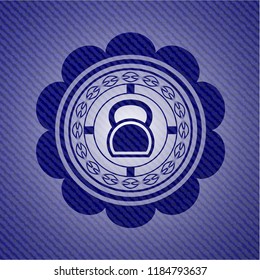 kettlebell icon inside badge with denim background