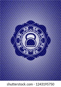 kettlebell icon inside badge with denim background
