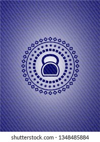 kettlebell icon inside badge with jean texture