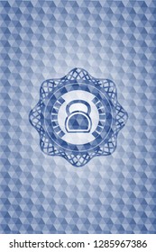 kettlebell icon inside blue badge with geometric pattern.