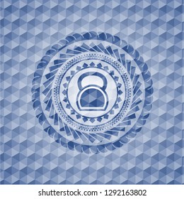 kettlebell icon inside blue badge with geometric pattern.