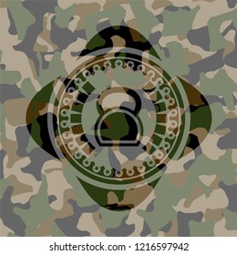 kettlebell icon inside camouflaged emblem