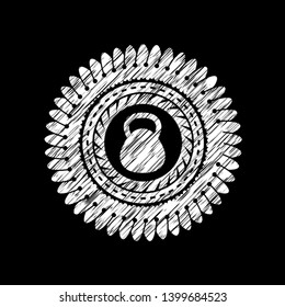 kettlebell icon inside chalk emblem written on a blackboard