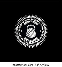 kettlebell icon inside chalk emblem written on a blackboard