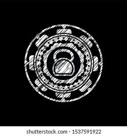 kettlebell icon inside chalk emblem written on a blackboard