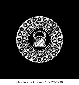 kettlebell icon inside chalk emblem written on a blackboard