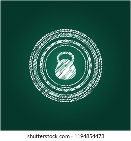 kettlebell icon inside chalkboard emblem on black board