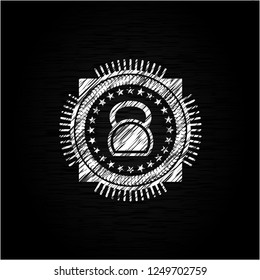 kettlebell icon inside chalkboard emblem on black board