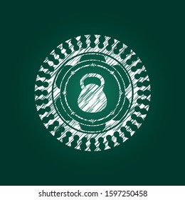 kettlebell icon inside chalkboard emblem on black board