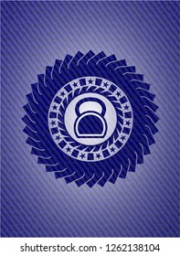 kettlebell icon inside denim background