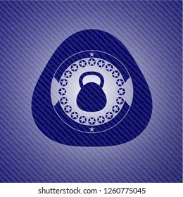 kettlebell icon inside emblem with denim texture