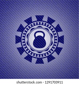 kettlebell icon inside emblem with denim texture
